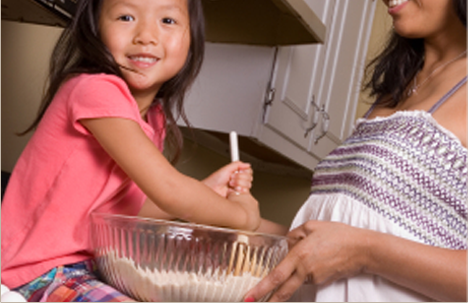 Preschooler helping cook