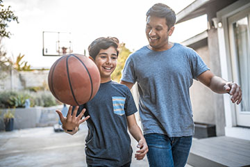 Father and son playing basketball